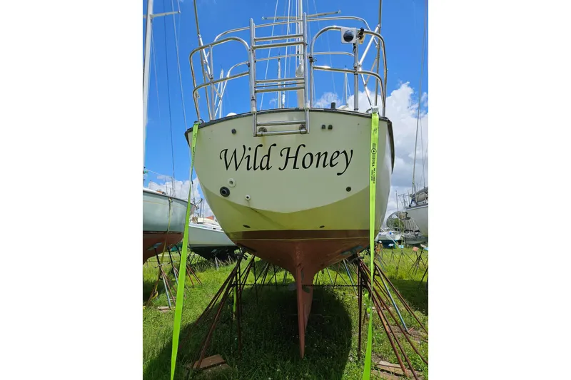 Slide: The Image of 1988 Cape Dory 36 sailboat "Wild Honey" on stands, blue sky background. - 35