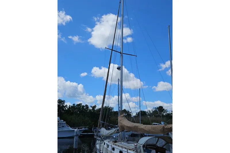 Slide: The Image of Sailboat Cape Dory 38, 1988 model, docked under a clear blue sky. - 8