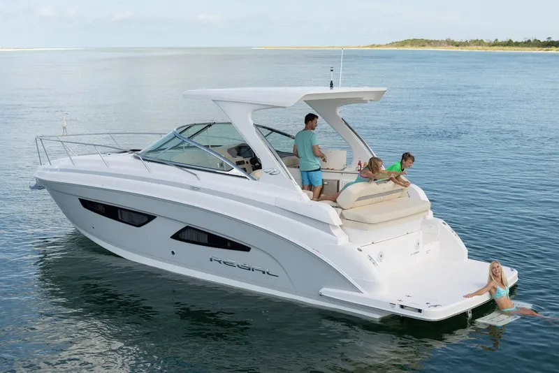 Slide: The Image of Manufacturer Provided Image: 2026 Regal 33 Express yacht on water with people enjoying leisure activities. - 2