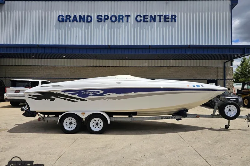 The Image of 2004 Baja H2X boat on trailer at Grand Sport Center dealership. - 1