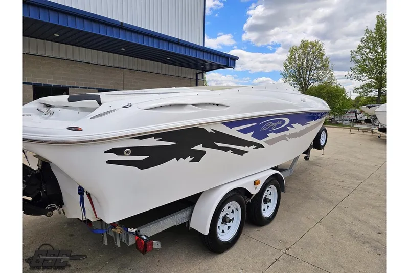 Slide: The Image of 2004 Baja H2X speedboat on trailer, featuring sleek design and bold graphics. - 10