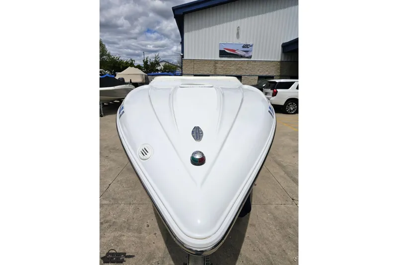 Slide: The Image of 2004 Baja H2X boat front view, parked outdoors near a building. - 15