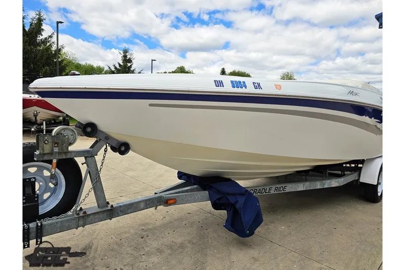 Slide: The Image of 2004 Baja H2X boat on trailer under cloudy sky. - 17