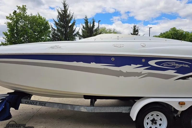 Slide: The Image of 2004 Baja H2X speedboat on trailer, featuring sleek design and vibrant graphics. - 22