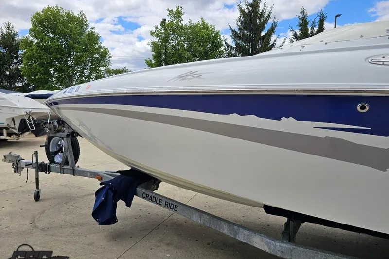 Slide: The Image of 2004 Baja H2X boat on trailer, featuring sleek design and vibrant blue accents. - 25