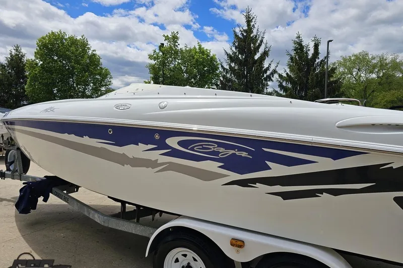 Slide: The Image of 2004 Baja H2X speedboat on trailer, featuring sleek design and vibrant graphics. - 26