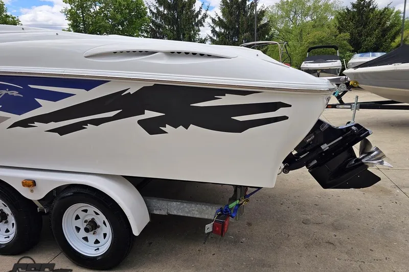 Slide: The Image of 2004 Baja H2X boat on trailer, featuring bold graphics and outboard motor. - 28