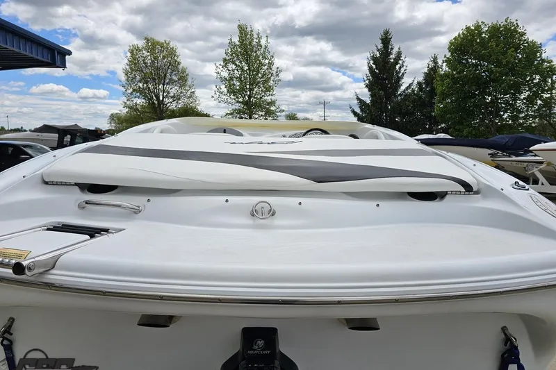 Slide: The Image of 2004 Baja H2X boat rear view, white with black accents, under cloudy sky. - 32