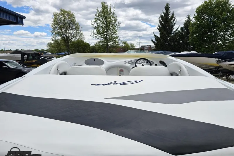 Slide: The Image of 2004 Baja H2X speedboat with sleek design, parked outdoors under a cloudy sky. - 34