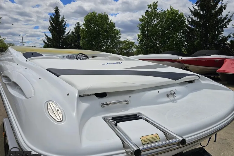 Slide: The Image of 2004 Baja H2X speedboat with sleek design, parked outdoors under a cloudy sky. - 35