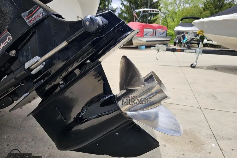 Slide: The Image of Close-up of a 2004 Baja H2X boat propeller, featuring a Quicksilver Mirage design. - 36