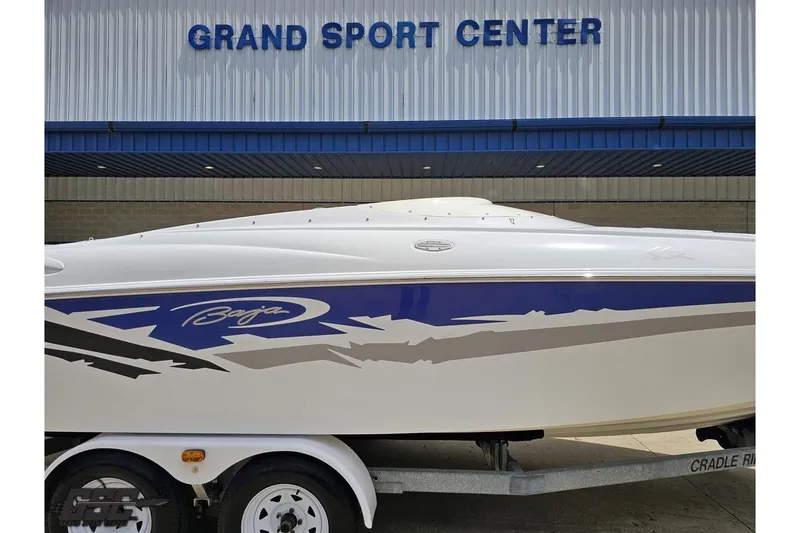Slide: The Image of 2004 Baja H2X boat on trailer at Grand Sport Center, featuring sleek design and graphics. - 4
