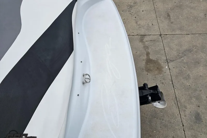 Slide: The Image of 2004 Baja H2X boat stern with sleek design and visible propeller on concrete surface. - 42