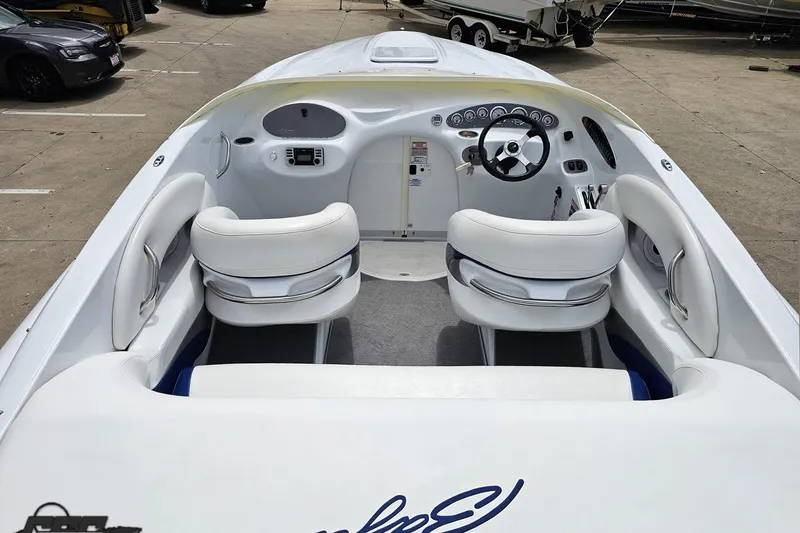 Slide: The Image of 2004 Baja H2X boat interior with white seating and modern dashboard controls. - 44