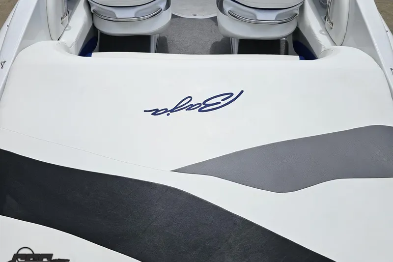Slide: The Image of 2004 Baja H2X boat interior with logo, featuring sleek white and gray upholstery. - 45
