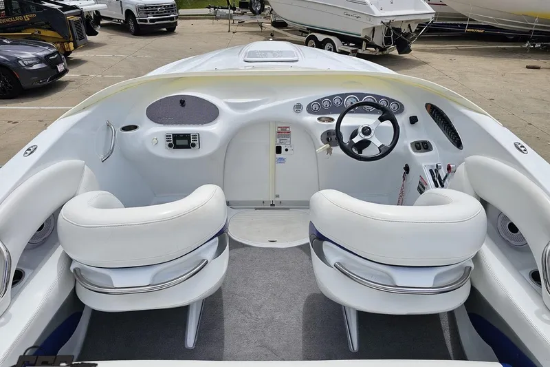 Slide: The Image of 2004 Baja H2X boat interior with white seating and modern dashboard controls. - 46