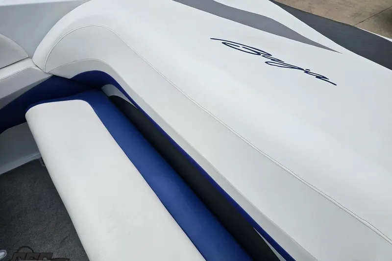 Slide: The Image of 2004 Baja H2X boat interior with white and blue seating, featuring sleek design elements. - 49