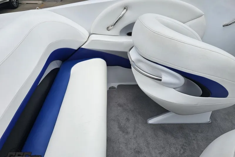 Slide: The Image of Interior of a 2004 Baja H2X boat featuring white and blue seating. - 51