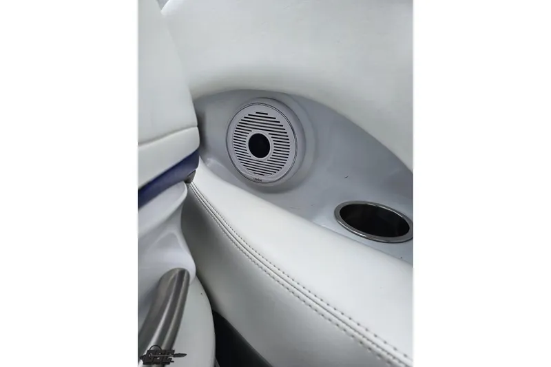 Slide: The Image of Interior of a 2004 Baja H2X boat featuring a speaker and cup holder. - 53