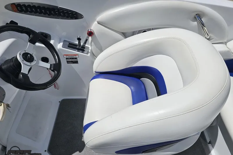 Slide: The Image of 2004 Baja H2X boat interior with steering wheel and white-blue seating. - 56