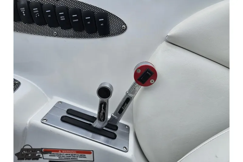 Slide: The Image of Throttle controls and switches in a 2004 Baja H2X boat cockpit. - 59