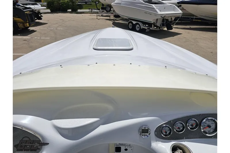 Slide: The Image of 2004 Baja H2X boat dashboard with gauges, parked in a marina. - 62