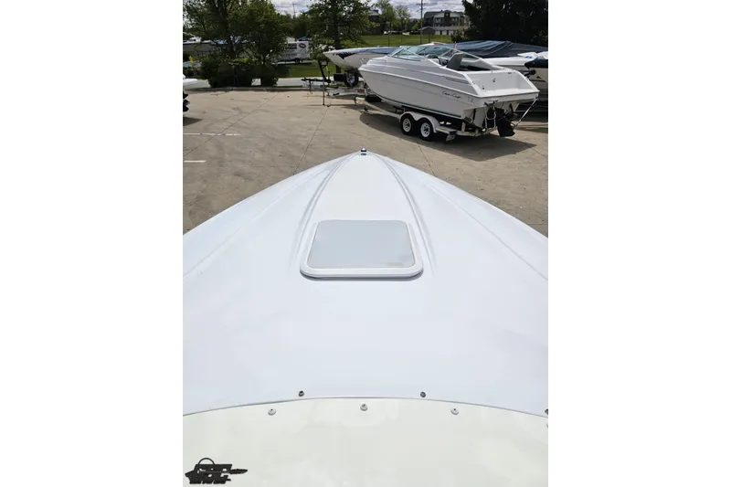 Slide: The Image of 2004 Baja H2X boat bow view in a marina with other boats. - 63