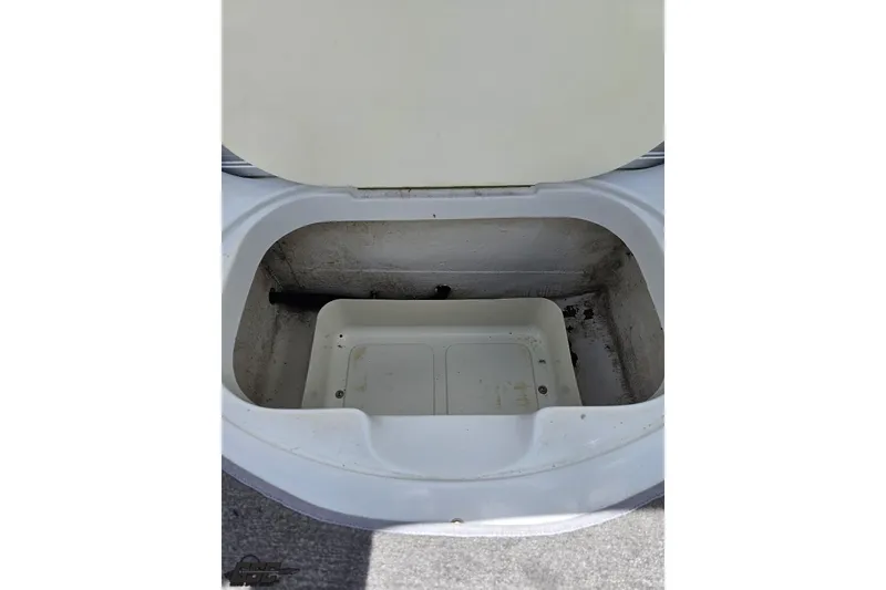 Slide: The Image of Open storage compartment in a 2004 Baja H2X boat, showing interior space. - 65