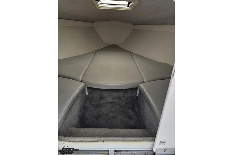 Slide: The Image of 2004 Baja H2X boat interior cabin with cushioned seating and carpeted flooring. - 66
