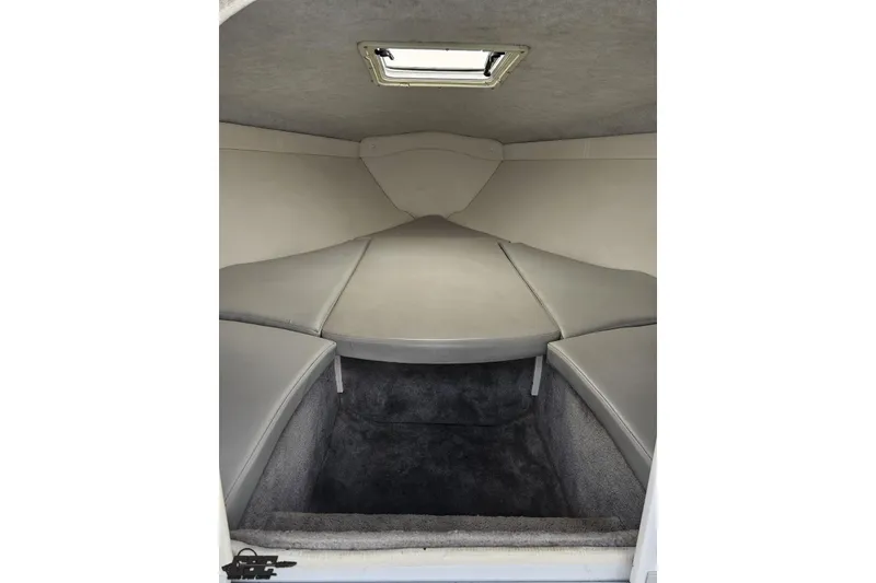 Slide: The Image of 2004 Baja H2X boat interior cabin with gray seating and carpeted flooring. - 67