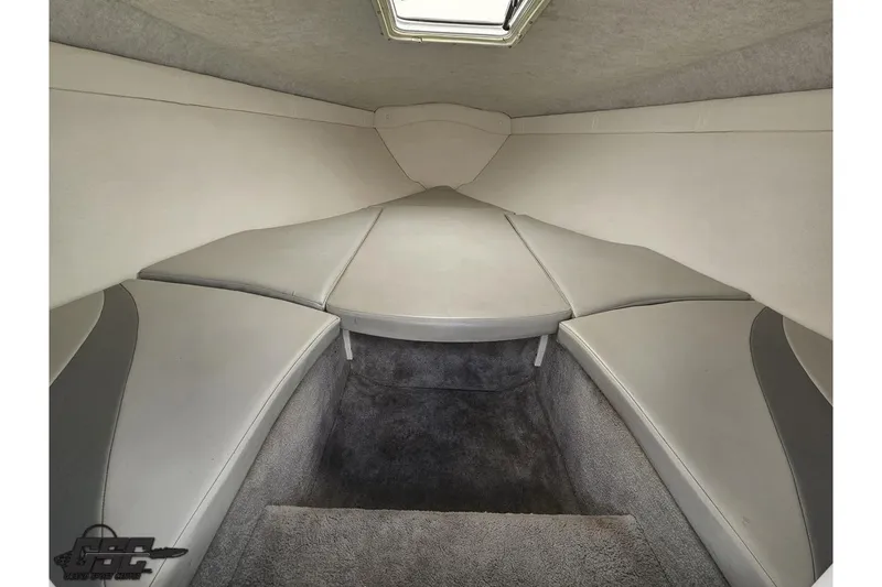 Slide: The Image of 2004 Baja H2X boat interior cabin with gray seating and carpeted flooring. - 68