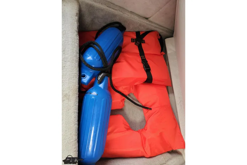 Slide: The Image of Blue boat fenders and orange life jackets in a 2004 Baja H2X storage compartment. - 70
