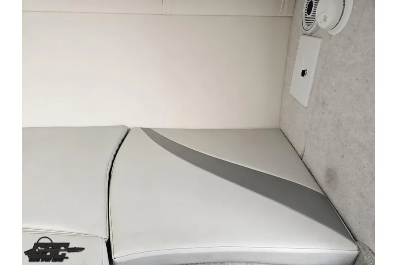 Slide: The Image of 2004 Baja H2X boat interior with white and gray seating and speaker detail. - 71