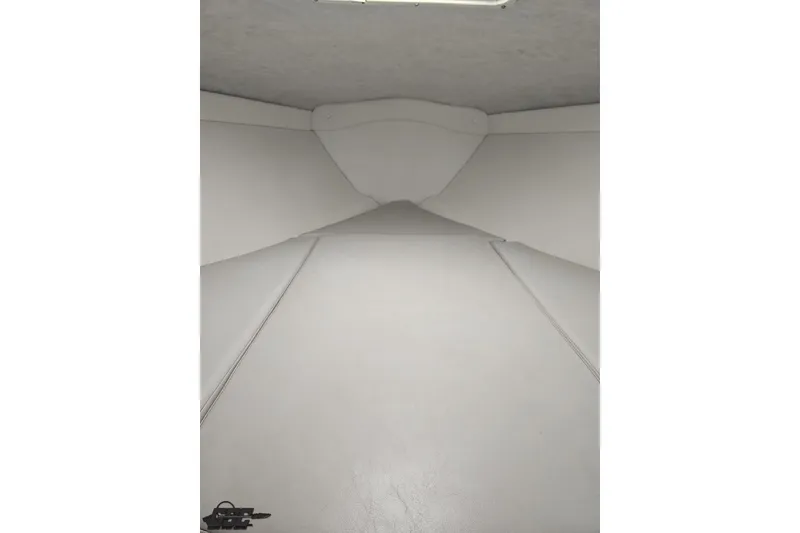 Slide: The Image of Interior cabin of a 2004 Baja H2X boat, featuring white upholstery. - 73