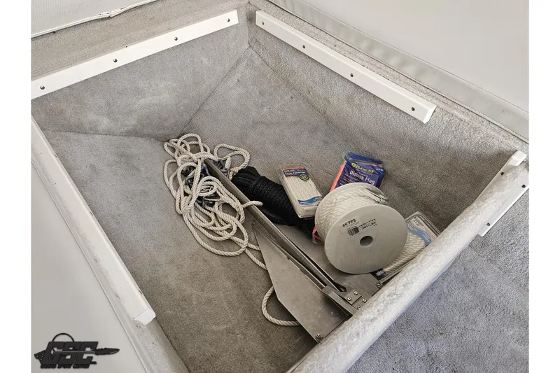 Slide: The Image of Storage compartment of a 2004 Baja H2X boat with ropes and anchor. - 74