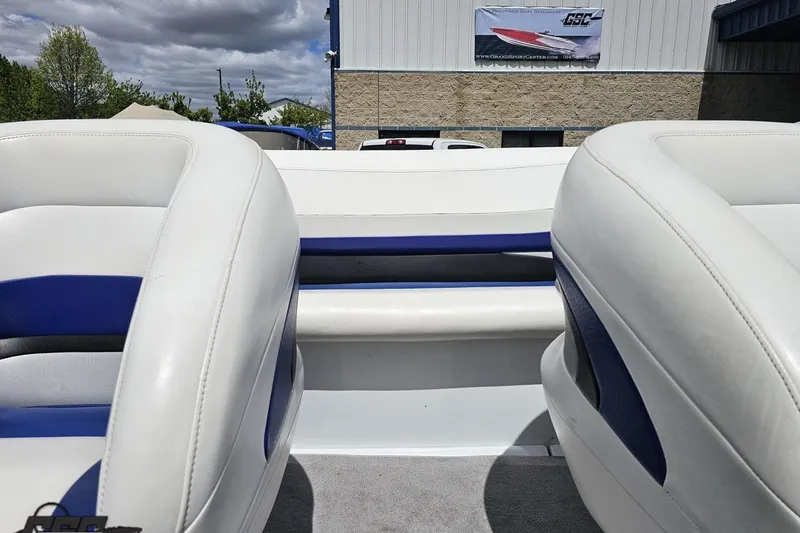 Slide: The Image of 2004 Baja H2X boat interior with white and blue seating, outdoor setting. - 79
