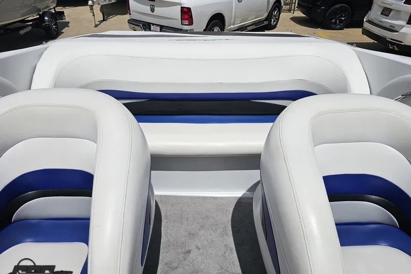 Slide: The Image of Interior of a 2004 Baja H2X boat with white and blue seating. - 80