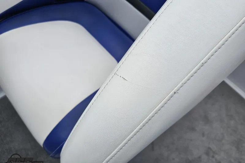 Slide: The Image of White and blue upholstery on a 2004 Baja H2X boat seat. - 81