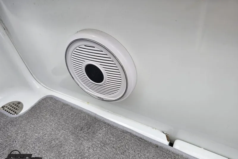 Slide: The Image of Speaker installed on a 2004 Baja H2X boat interior, featuring a white and gray design. - 83