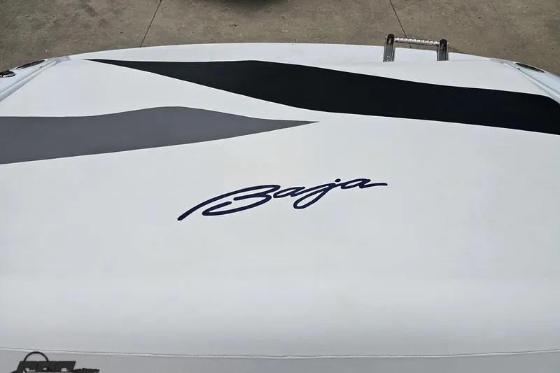 Slide: The Image of 2004 Baja H2X boat with sleek design and bold logo on deck. - 85