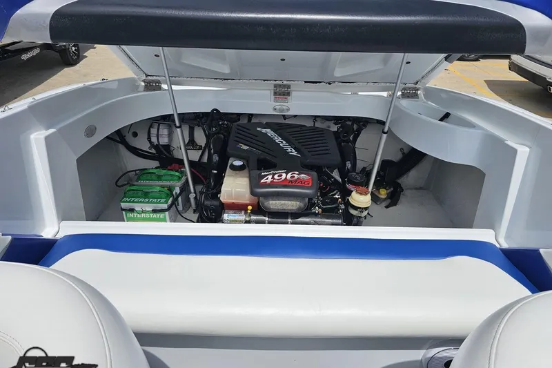 Slide: The Image of Open engine compartment of a 2004 Baja H2X boat, featuring a MerCruiser 496 MAG engine. - 86