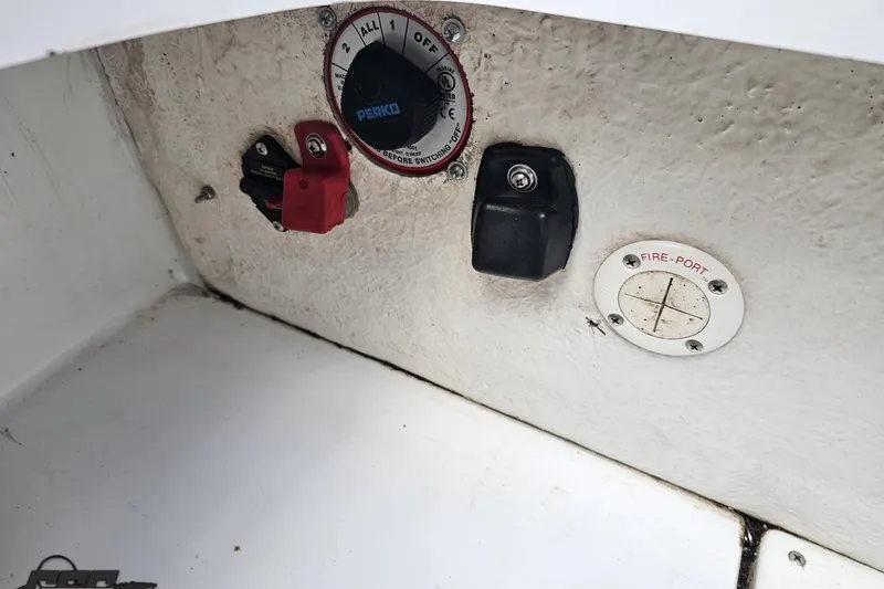 Slide: The Image of Control panel of a 2004 Baja H2X boat with switches and fire port. - 89