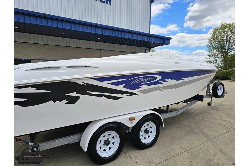 Slide: The Image of 2004 Baja H2X speedboat on trailer, featuring sleek design and bold graphics. - 9