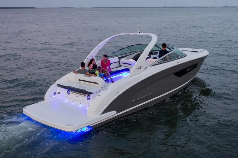 Slide: The Image of Manufacturer Provided Image: 2026 Regal 3300 boat cruising with passengers, featuring sleek design and blue LED lights. - 6