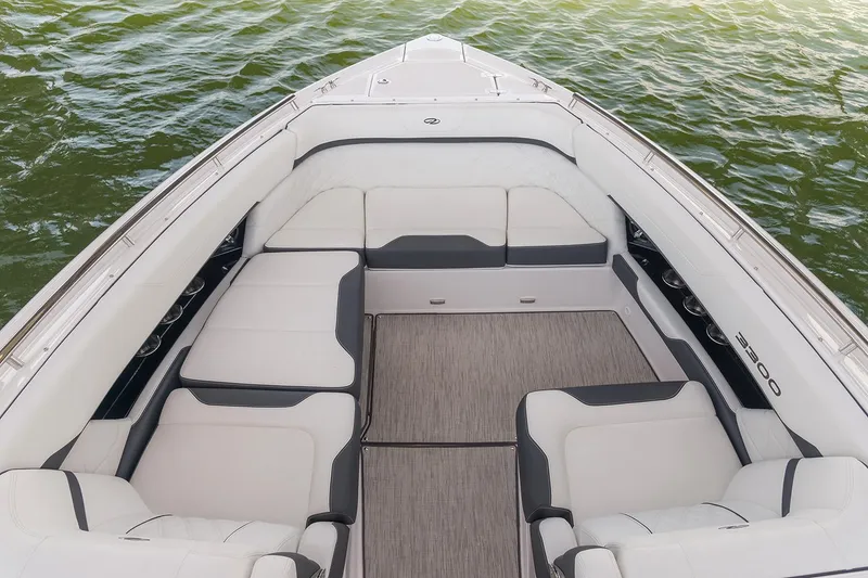 Slide: The Image of Manufacturer Provided Image: Luxurious seating area on a 2026 Regal 3300 boat, overlooking calm green waters. - 7