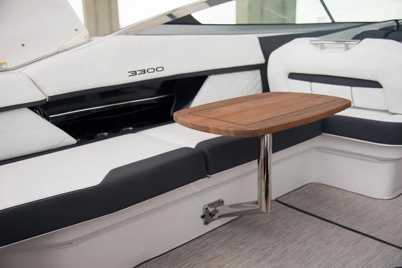 Slide: The Image of Manufacturer Provided Image: 2026 Regal 3300 boat interior with sleek seating and wooden table. - 9