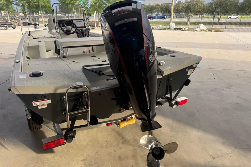 Slide: The Image of 2026 Ranger RB190 boat with outboard motor, parked on a trailer in a sunny outdoor setting. - 3