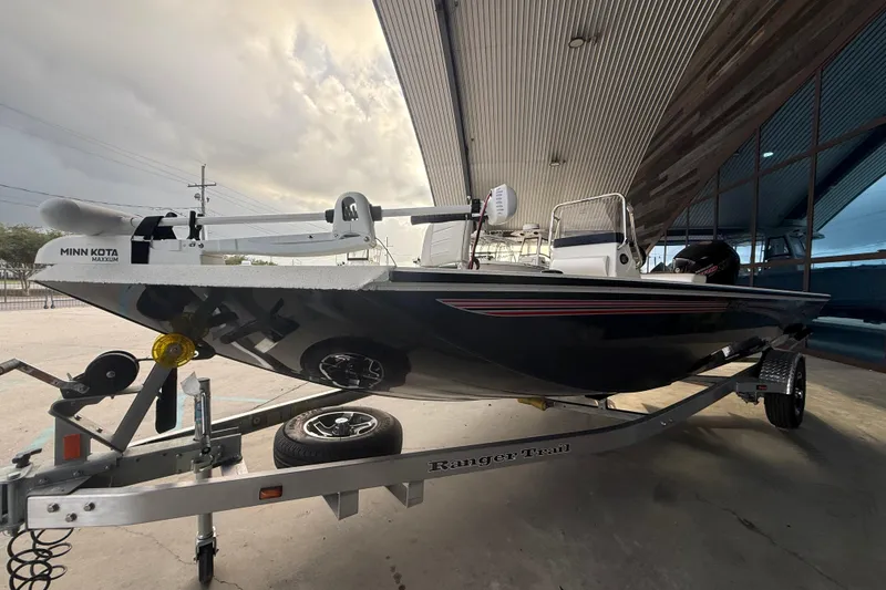 Slide: The Image of 2026 Ranger RB190 boat on trailer under a metal roof, featuring Minn Kota Maxxum motor. - 5