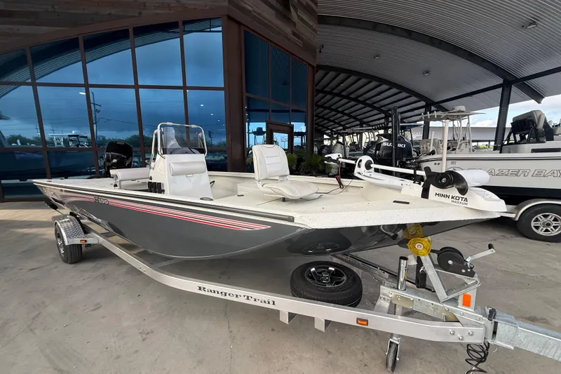 Slide: The Image of 2026 Ranger RB190 boat on trailer, displayed in a showroom with modern architecture. - 6