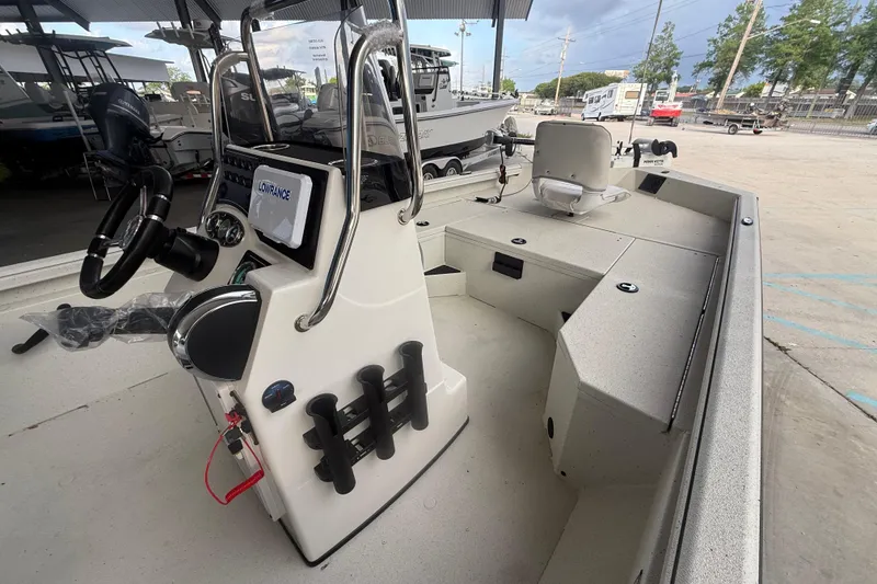 Slide: The Image of 2026 Ranger RB190 boat interior with steering console and seating in a showroom. - 7